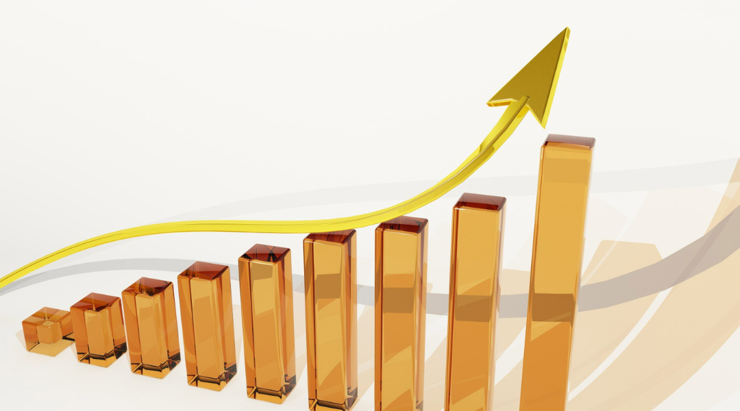 Golden bar graph with an upward arrow indicating business growth and success